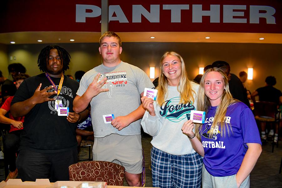 Student winners at our annual puzzle competition holding their gift cards. 