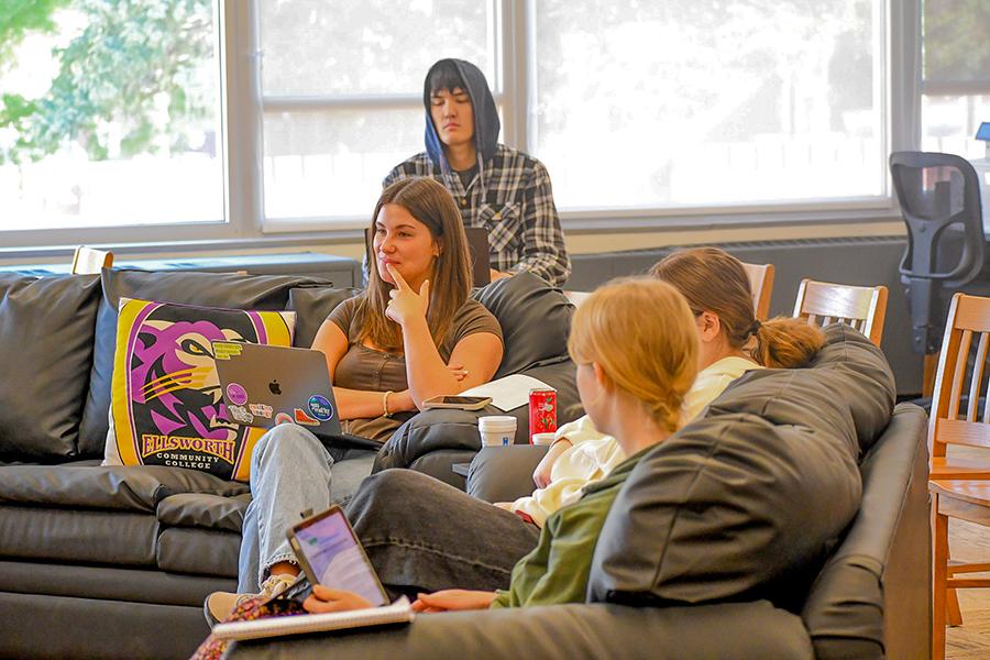 Students sitting in the library listening to a guest speaker during Coffee Talk. 