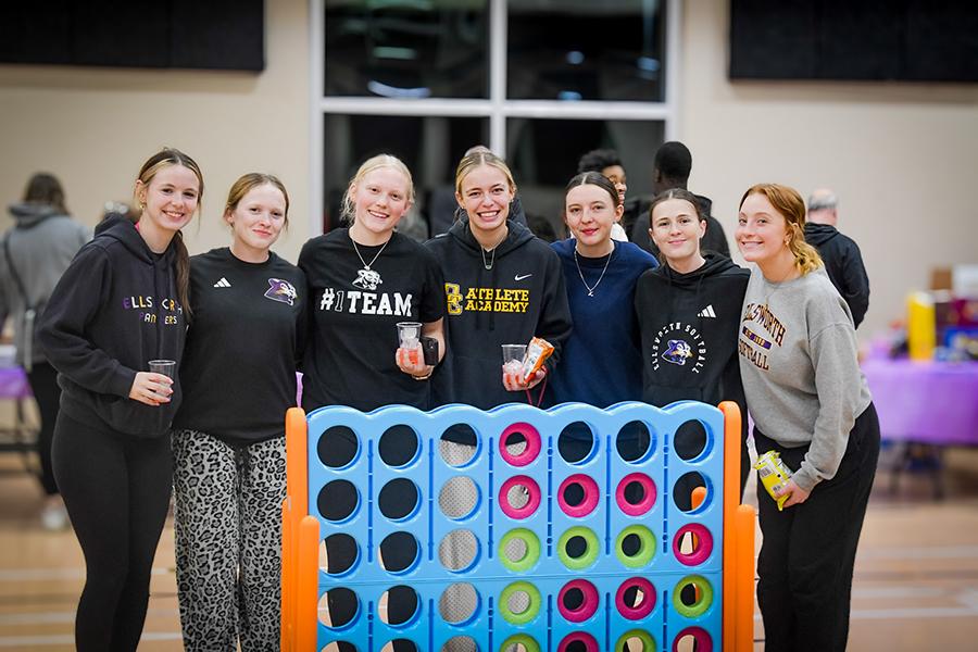 Students gathered around a giant connect four game.