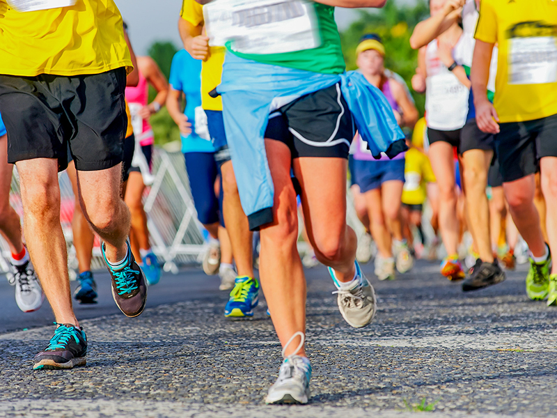 Pciture of students legs during a road race. 