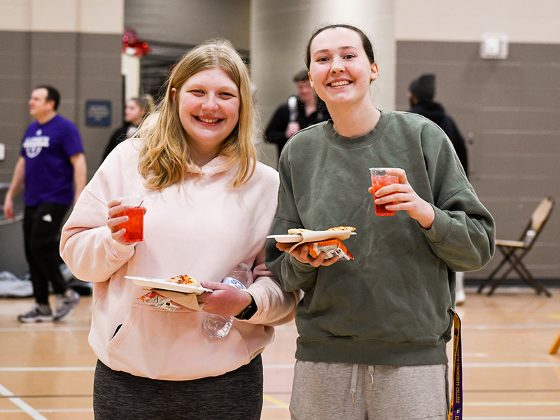 Students enjoying pizza during the winter carnival.