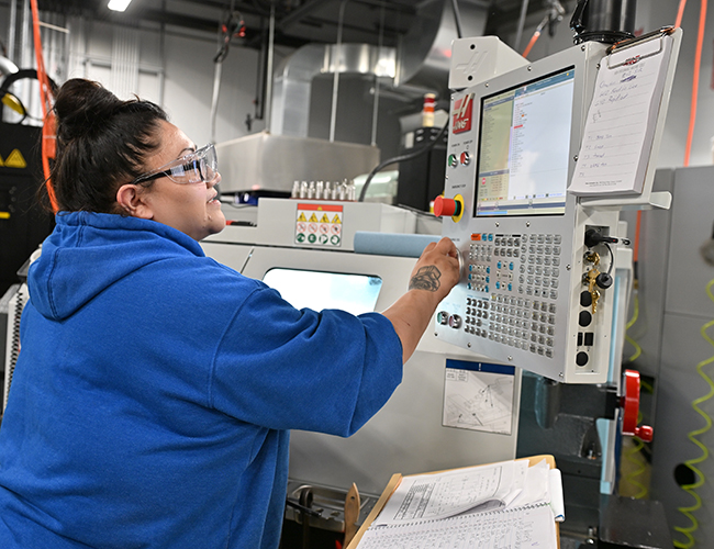 female student working on machine