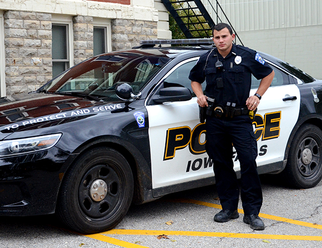 police officer in front of squad car
