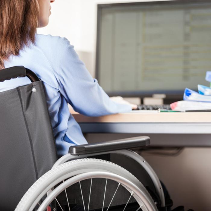 person in wheel chair at computer